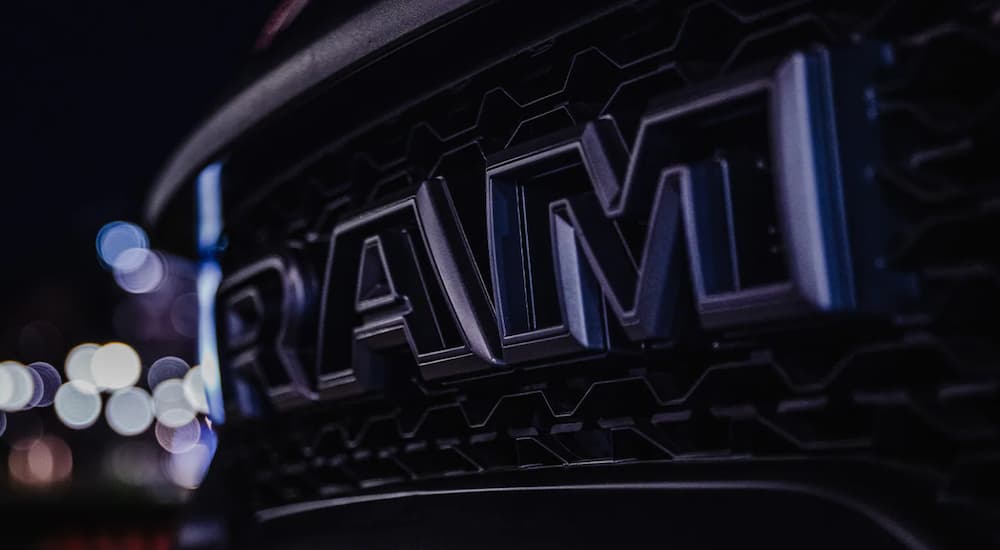 Close up of a the Ram logo on the grille of a Ram 1500 TRX.