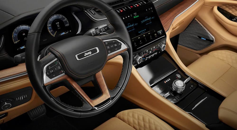 The tan and black interior of a 2022 Jeep Grand Cherokee L for sale at a Glassboro Jeep dealer.