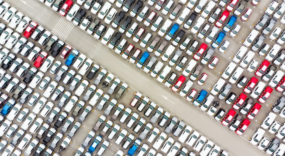 Aerial view of a large lot of certified pre-owned vehicles parked in tidy rows. 