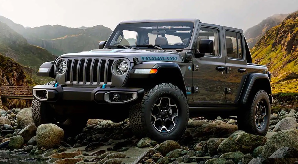 A grey 2022 Jeep Wrangler Rubicon 4xe parked on a rocky trail.