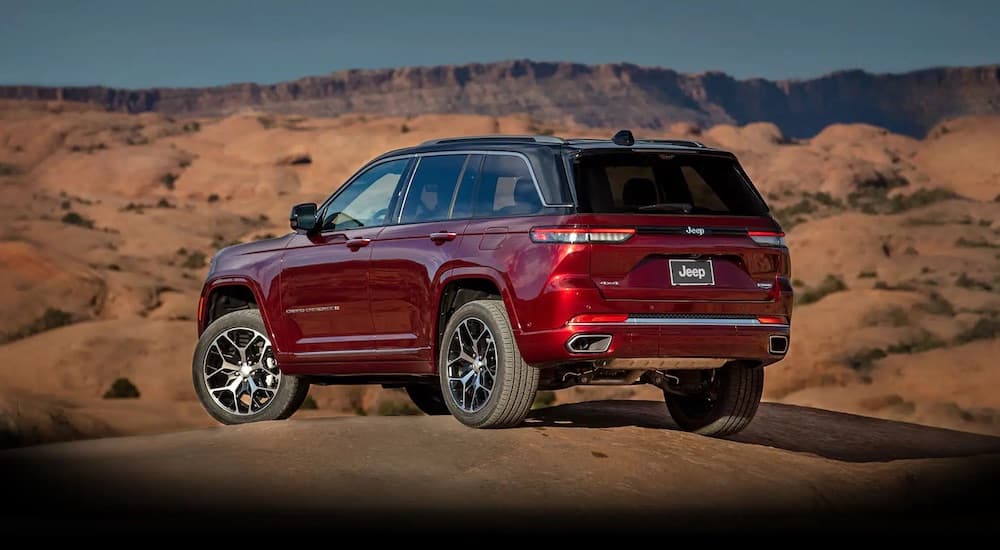 A red 2022 Jeep Grand Cherokee overlooking the desert while off-roading