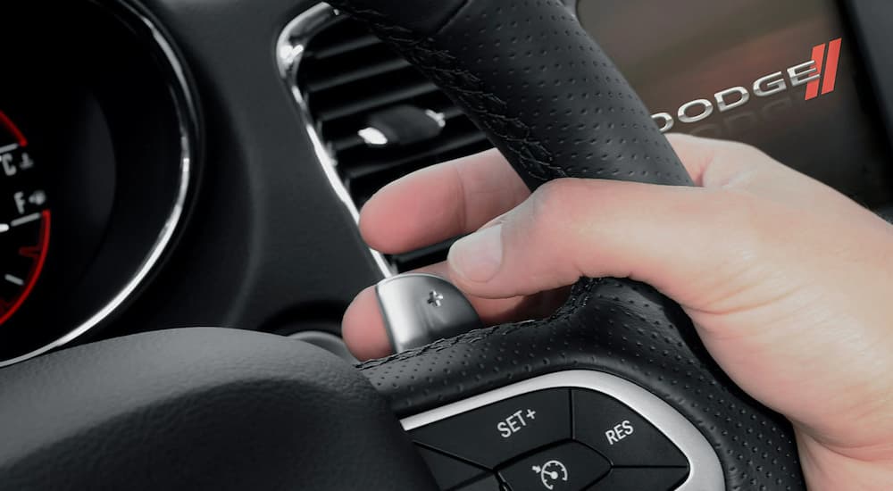 A close-up of the paddle shifters on the steering wheel of a 2022 Dodge Charger