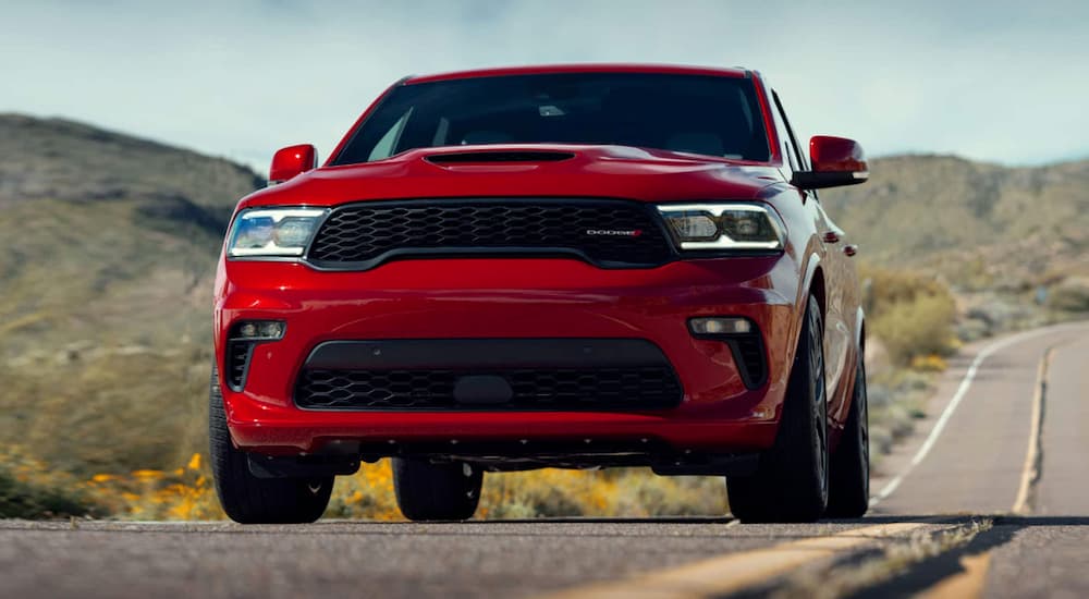 Front view of a red 2023 Dodge Durango driving on an open road