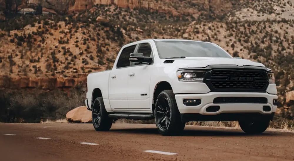 A white 2023 Ram 1500 is shown from the front at an angle.