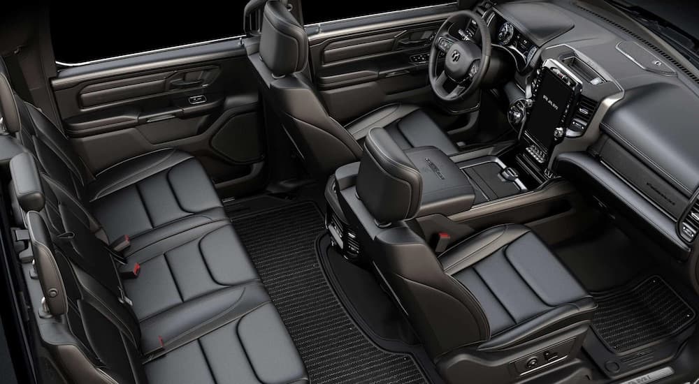 The black interior of a 2023 Ram 1500 is shown from a high angle after leaving a dealer that has a Ram 1500 for sale.