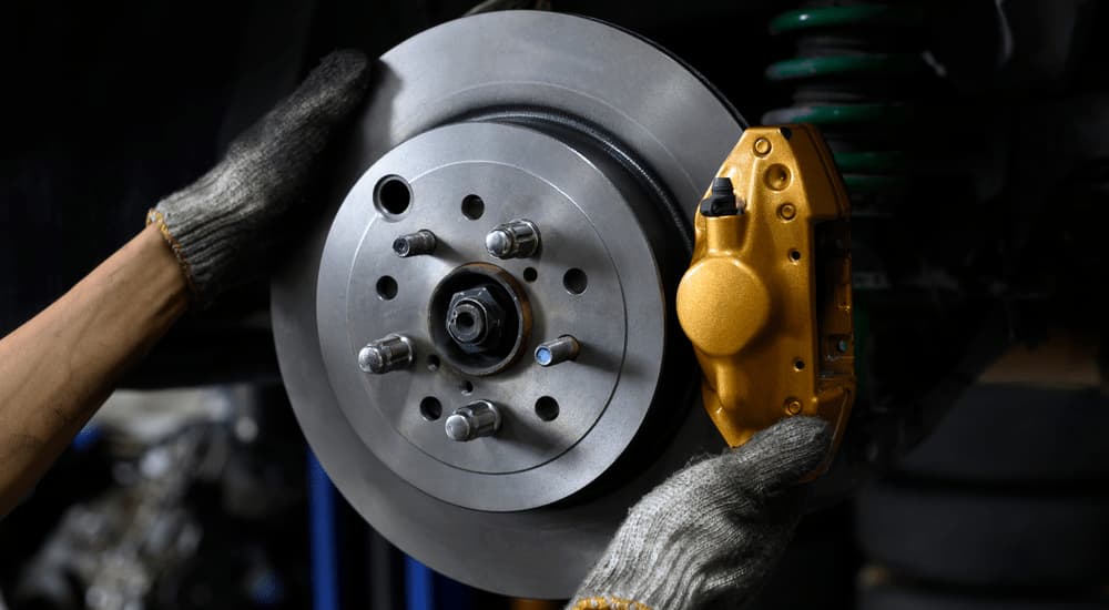 A mechanic installing a new rotor during a brake repair.