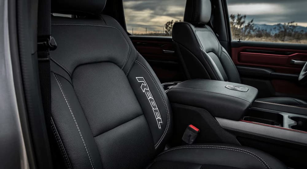 The black interior of a 2023 Ram 1500 Rebel, seen from the passenger side front door.