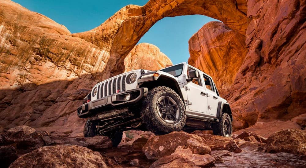 A white 2020 Jeep Wrangler is shown from the front at an angle after leaving a dealer with a certified Jeep mechanic.