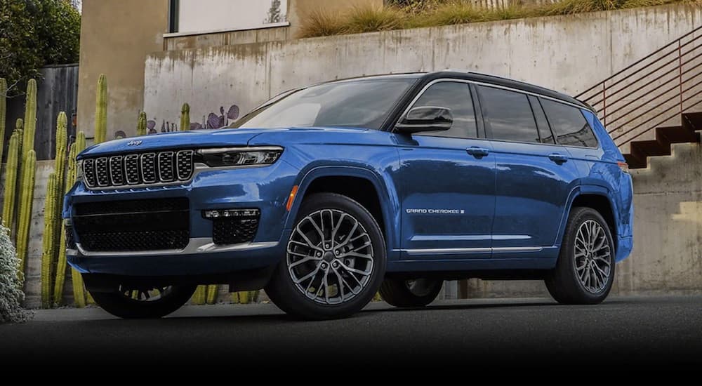 A blue 2022 Jeep Grand Cherokee is shown from the front at an angle.