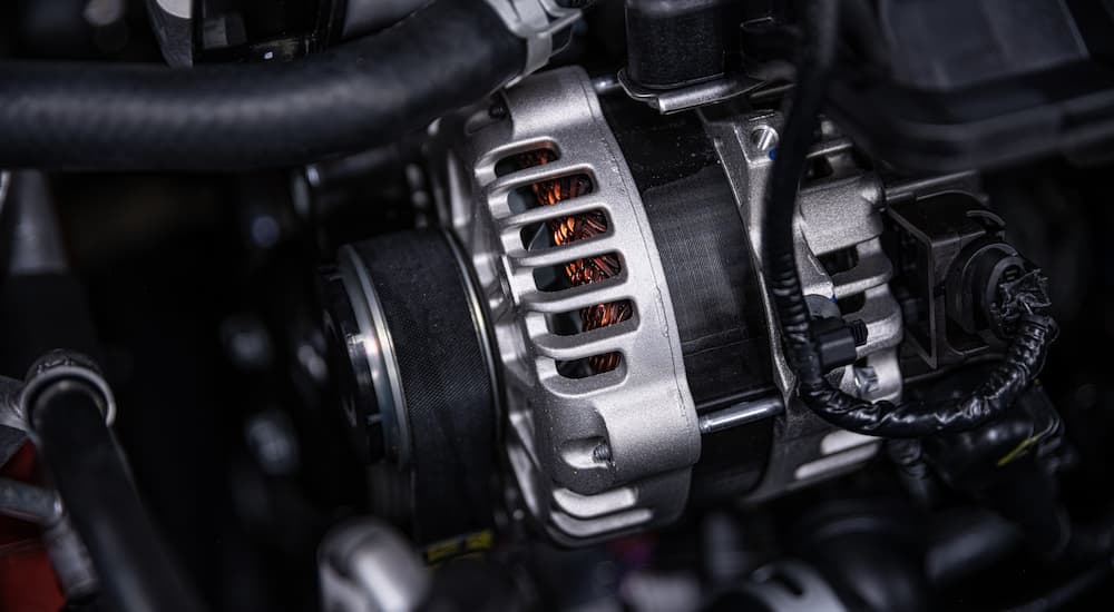 A close up of an alternator is shown getting car repair near you.
