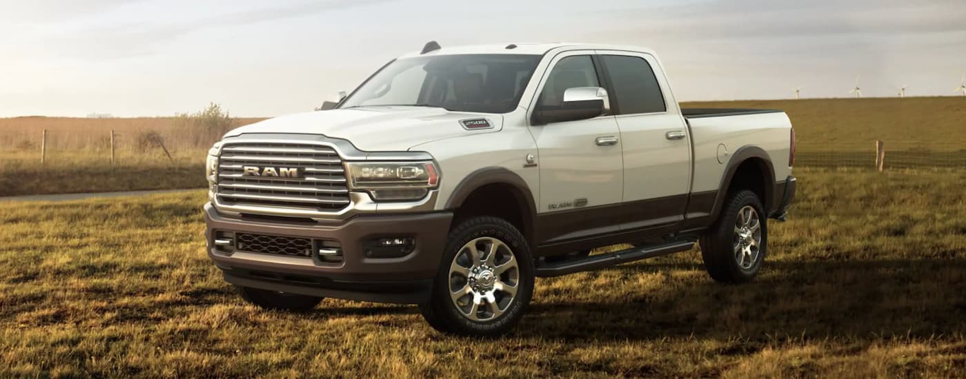 A white 2021 Ram 2500 is parked in a field after leaving a Ram dealership in NJ