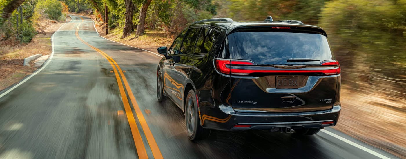 A black 2021 Chrysler Pacifica is shown from a rear angle after visiting a certified pre-owned Chrysler dealer.
