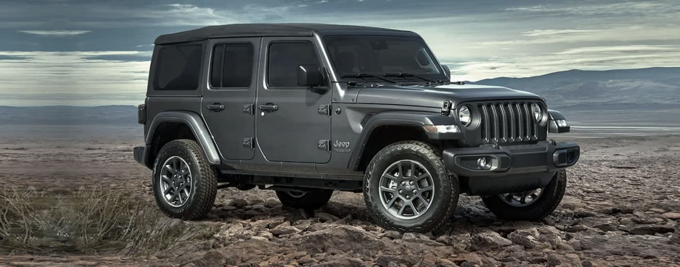 A grey 2022 Jeep is shown from the side parked in the desert.
