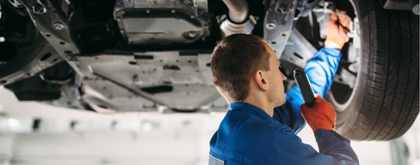 A mechanic is shown performing a multi-point inspection.
