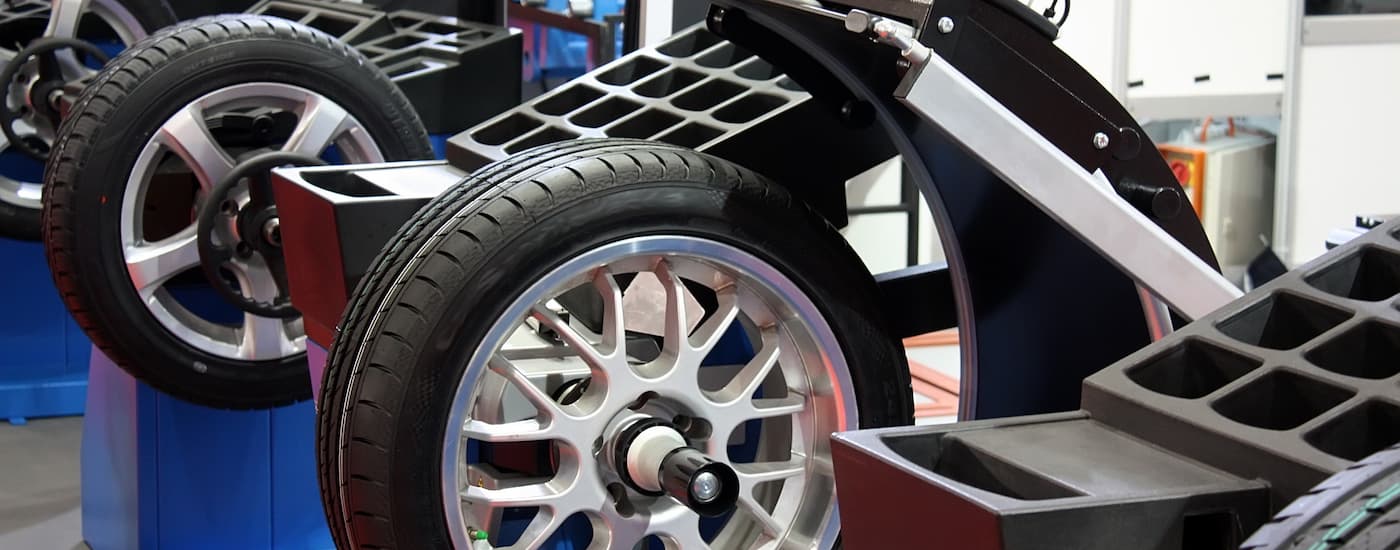 Two tires are shown being balanced at a vehicle service center.