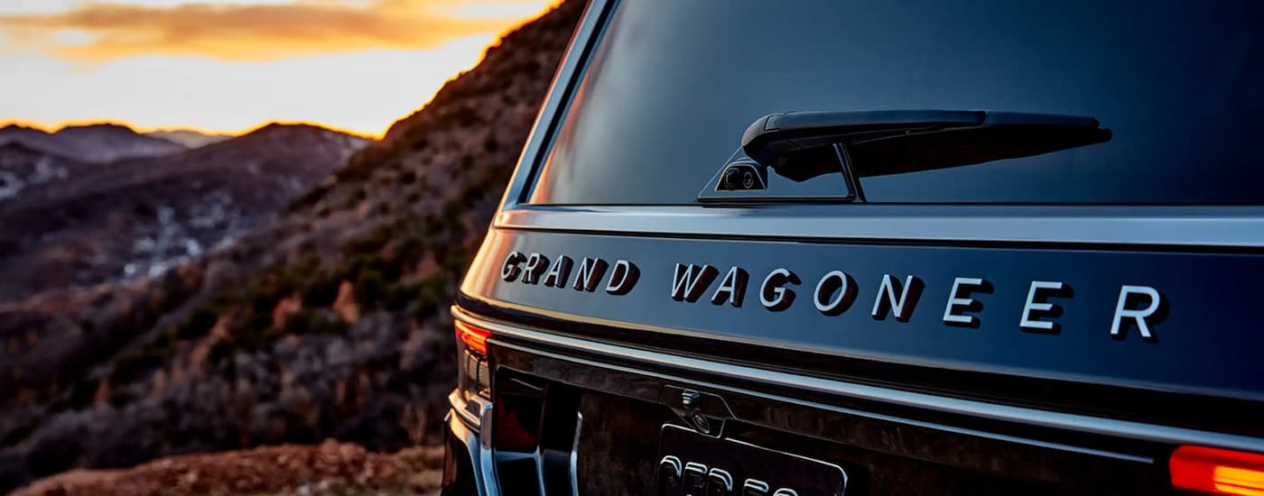 A close up of the rear Grand Wagoneer badge is shown on a black 2022 Grand Wagoneer.